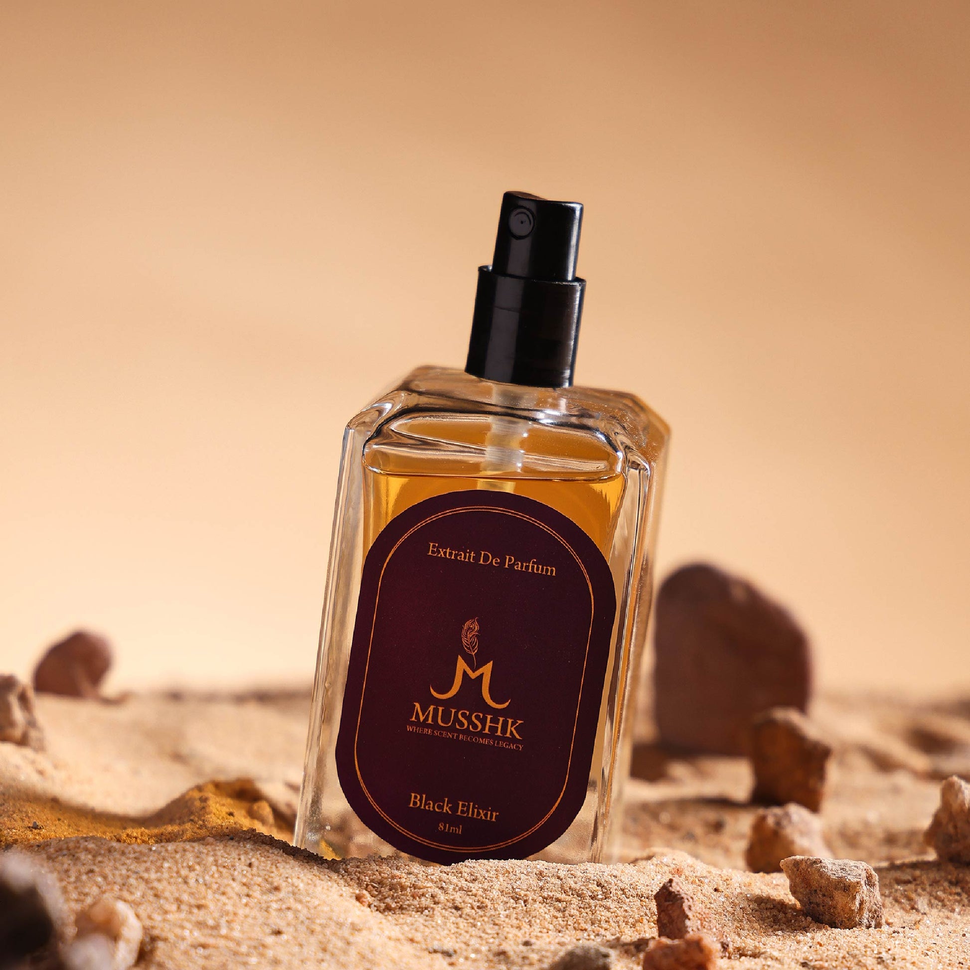 Musshk Black Elixir extrait de parfum bottle with premium luxury fragrance on sandy background