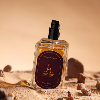 Musshk Black Elixir extrait de parfum bottle with premium luxury fragrance on sandy background